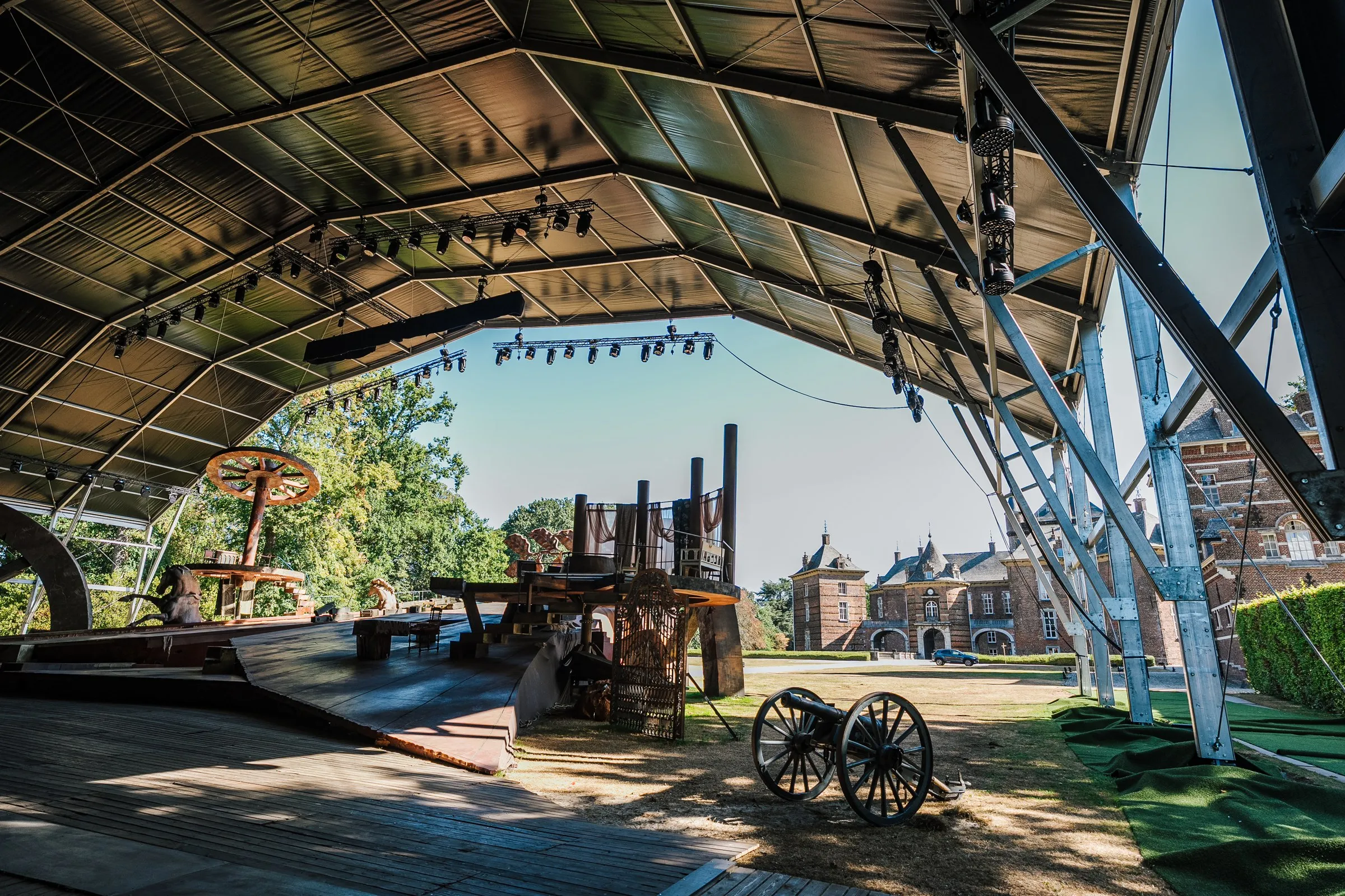 Covered stage with set and cannon, castle in the background