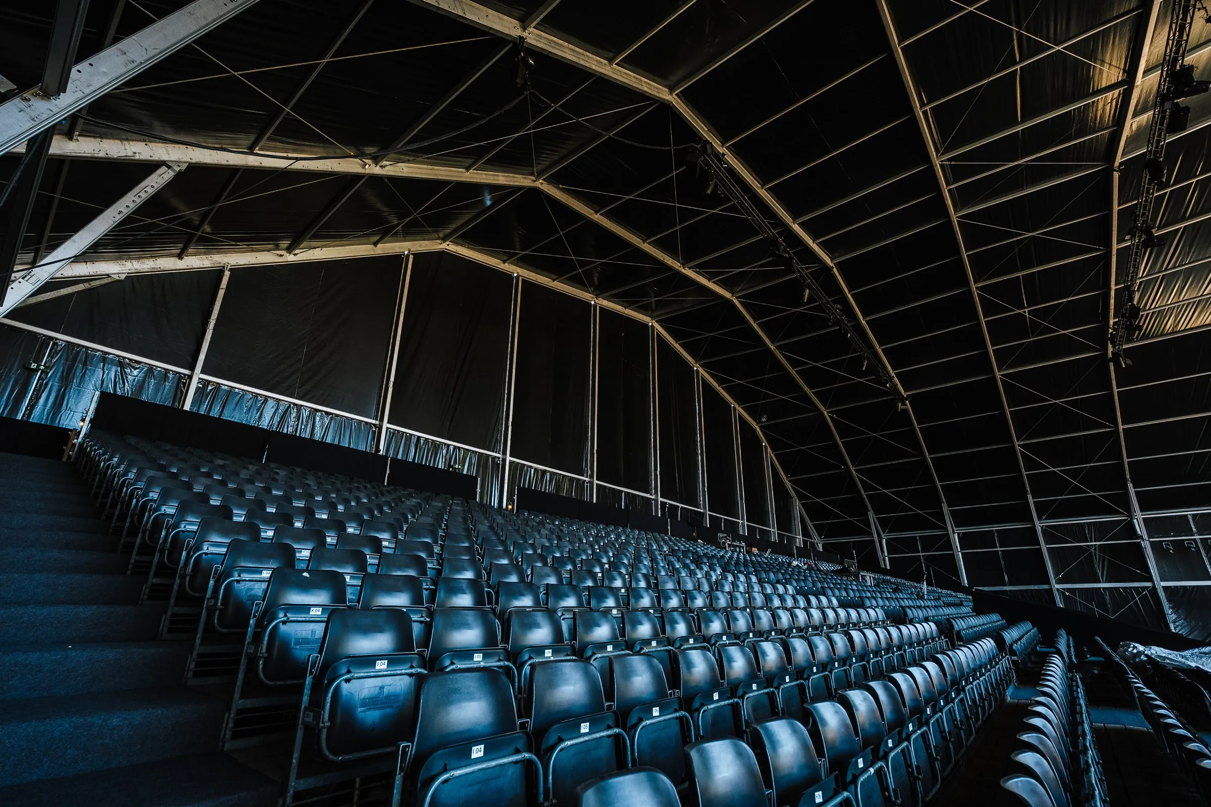 Empty seating under a large metal structure